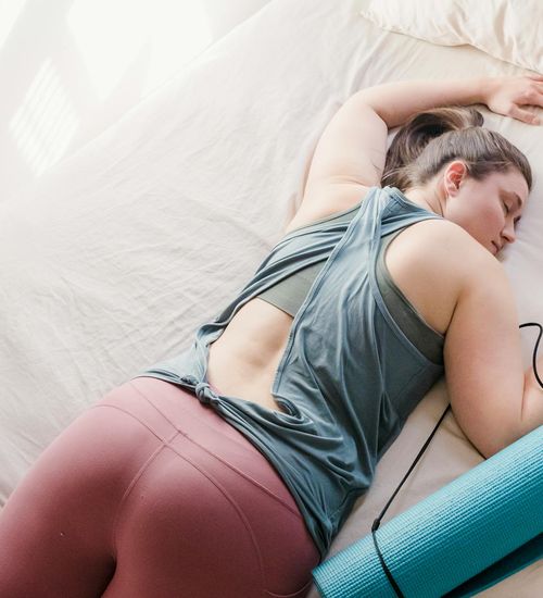 Person relaxing in a restorative yoga pose.